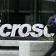 A woman rushes by Microsoft headquarters.